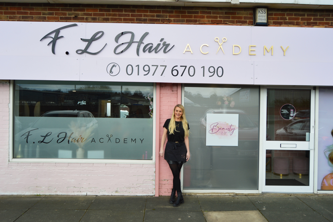 Faye, the Salon owner stood in front of the building.